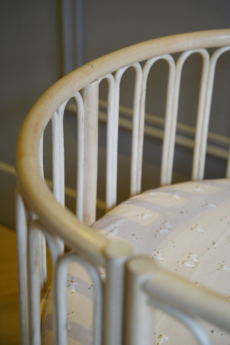 Detail van de ronde rotan spijlen van meegroeibed Sol